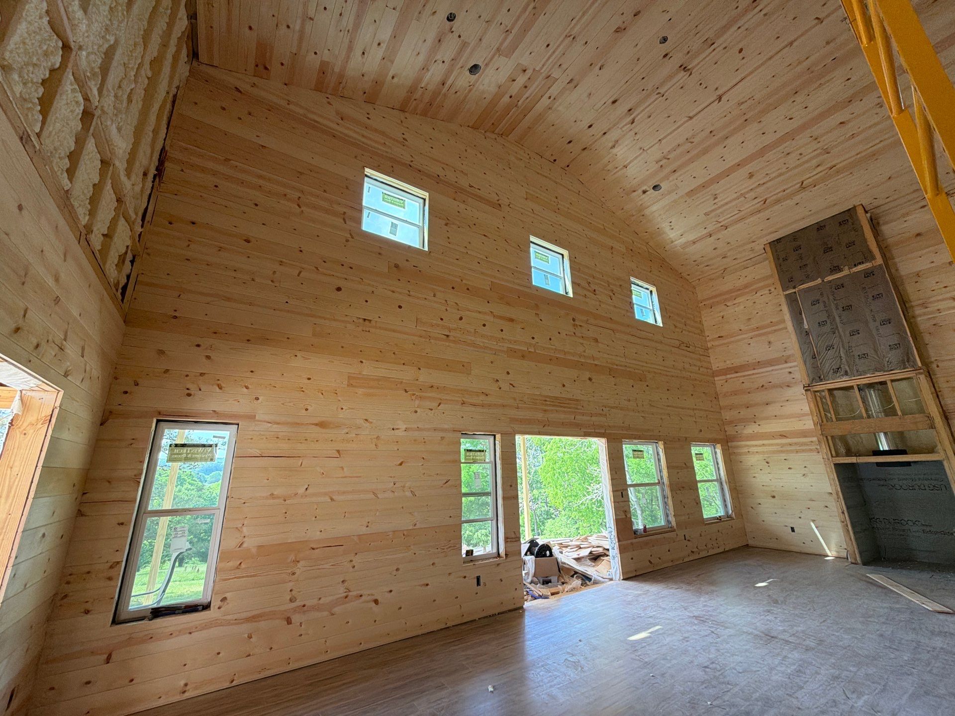 Finished interior great room with tongue-and-groove pine ceiling and hardwood floors